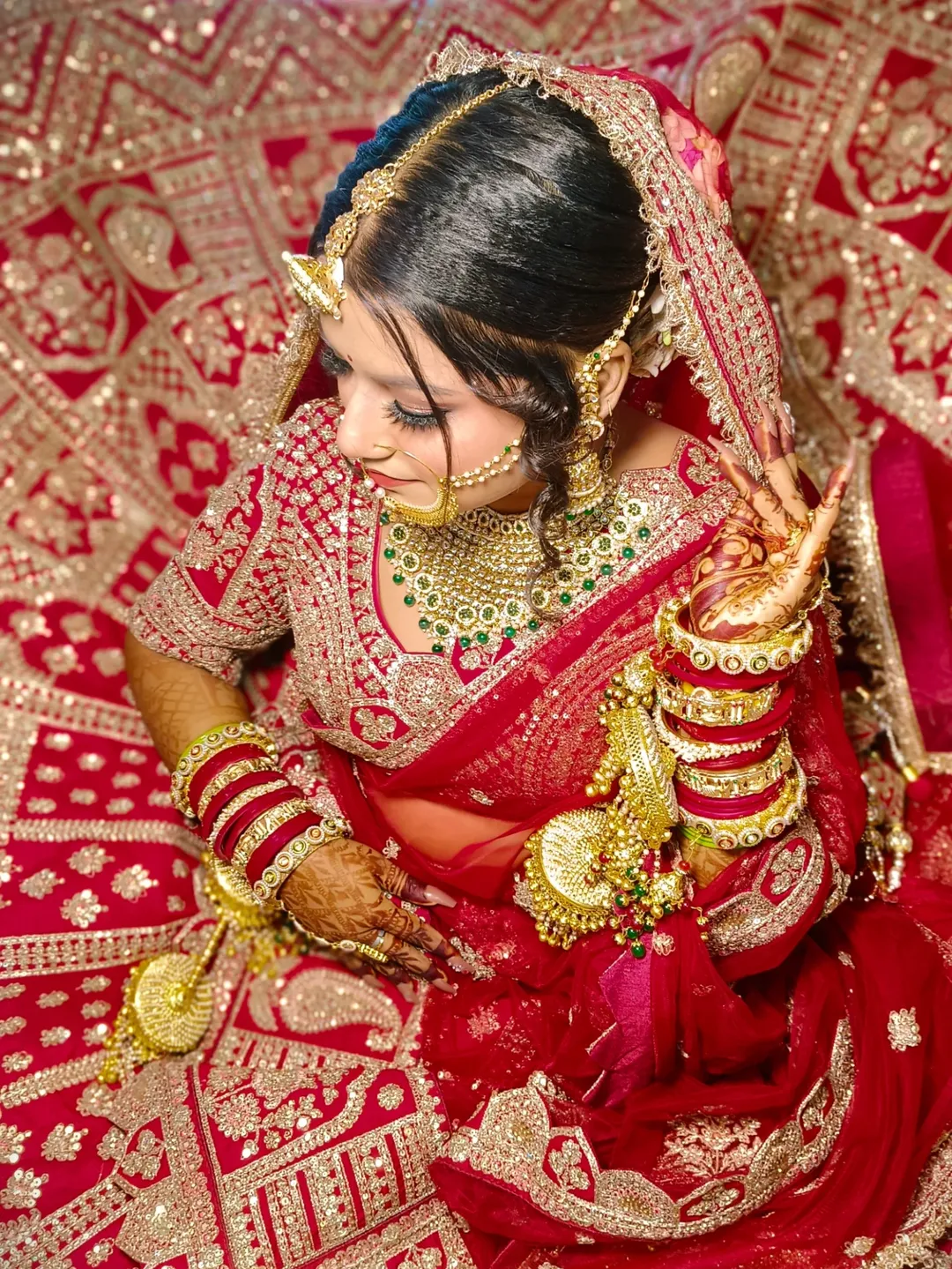 Stunning Indian bride with intricate gold jewelry and glowing makeup